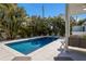 Sparkling blue pool with a spacious patio area at 307 Spring Ave, Anna Maria, FL 34216