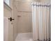Clean bathroom with a shower/tub combo, tile surround, and updated fixtures at 312 61St St # B, Holmes Beach, FL 34217