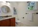 Bathroom with a single vanity, toilet, and decorative mirror at 312 61St St # B, Holmes Beach, FL 34217