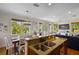 Kitchen with granite island, breakfast bar, and dining area at 312 61St St # B, Holmes Beach, FL 34217