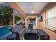 Relaxing patio with seating, pool view, and TV at 312 61St St # B, Holmes Beach, FL 34217