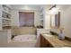 Relaxing bathroom with a soaking tub, granite countertops, and ample vanity space at 312 61St St # B, Holmes Beach, FL 34217