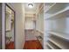 Walk-in closet with custom shelving for optimal storage in a well-lit, organized space at 312 61St St # B, Holmes Beach, FL 34217