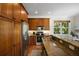Well-equipped kitchen with stainless steel appliances, granite countertops, and ample wood cabinetry at 312 61St St # B, Holmes Beach, FL 34217