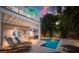 Inviting swimming pool surrounded by lounge chairs, lush landscaping, and a covered patio area at 312 61St St # B, Holmes Beach, FL 34217