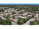 Community view showing condo buildings, pool, and lush green surroundings at 3207 Beneva Rd # 102, Sarasota, FL 34232