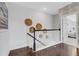 Upstairs hallway with wood floors and access to bedrooms at 342 Via Anina Dr, Sarasota, FL 34243