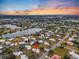 Aerial view of a lakeside community at sunset, showing home's location at 430 Botticelli Dr # 430, Nokomis, FL 34275