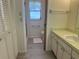 Well-lit bathroom with a neutral color scheme, a walk-in shower, and a vanity with a sink at 430 Botticelli Dr # 430, Nokomis, FL 34275