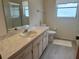 The bathroom features a spacious vanity, ample lighting, and a shower with glass doors at 430 Botticelli Dr # 430, Nokomis, FL 34275