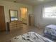Comfortable bedroom with two beds, a dresser, and a view into the en suite bathroom at 430 Botticelli Dr # 430, Nokomis, FL 34275