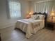 Cozy bedroom with a queen-size bed, matching nightstands, and a soft color palette at 430 Botticelli Dr # 430, Nokomis, FL 34275