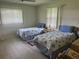 Comfortable bedroom featuring two twin beds with seashell bedding, complemented by neutral walls and natural light at 430 Botticelli Dr # 430, Nokomis, FL 34275