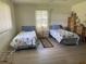 Cozy bedroom featuring twin beds with seashell bedding, light wood furniture, and natural light at 430 Botticelli Dr # 430, Nokomis, FL 34275