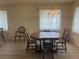 Bright dining area with a large table perfect for entertaining, complemented by natural light and neutral decor at 430 Botticelli Dr # 430, Nokomis, FL 34275