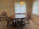 Dining room featuring a large table with seating for six, an elegant chandelier, and natural light from the window at 430 Botticelli Dr # 430, Nokomis, FL 34275