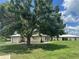 Charming villa with a well-maintained lawn and mature tree in a sunny residential neighborhood at 430 Botticelli Dr # 430, Nokomis, FL 34275