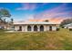 Inviting home features neutral stucco, arched doorways, manicured lawn, and meticulous landscaping at 430 Botticelli Dr # 430, Nokomis, FL 34275
