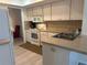 Functional kitchen features white appliances and cabinets, neutral countertops and flooring at 430 Botticelli Dr # 430, Nokomis, FL 34275