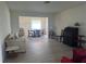 Open-concept living room with wood flooring, neutral paint, with large window to let light in at 430 Botticelli Dr # 430, Nokomis, FL 34275
