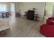 Open living room featuring neutral paint, wood-look flooring, comfortable seating, and a glimpse into the dining area at 430 Botticelli Dr # 430, Nokomis, FL 34275