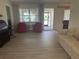 Bright living room featuring stylish furniture, neutral walls, and elegant arched windows overlooking the front yard at 430 Botticelli Dr # 430, Nokomis, FL 34275