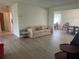 A well-lit living room features laminate flooring and a view into the dining room at 430 Botticelli Dr # 430, Nokomis, FL 34275