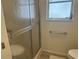 Close-up of the bathroom shower with a glass door and a convenient grab bar for accessibility at 430 Botticelli Dr # 430, Nokomis, FL 34275