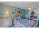 Guest bedroom with full-size bed and view into living area at 4460 Ironwood Cir # 403A, Bradenton, FL 34209