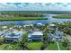 Aerial view of stunning waterfront homes nestled amidst lush greenery and winding waterways at 506 S Casey Key Rd, Nokomis, FL 34275