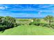 Expansive backyard featuring lush green grass and beautiful ocean views at 506 S Casey Key Rd, Nokomis, FL 34275