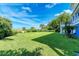 Expansive, lush backyard with manicured lawn leads to beach access, offering serene outdoor space at 506 S Casey Key Rd, Nokomis, FL 34275