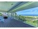 Relaxing covered balcony with ocean view, comfortable seating and durable composite decking at 506 S Casey Key Rd, Nokomis, FL 34275