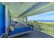 Inviting waterfront balcony featuring a comfortable porch swing for enjoying the ocean breeze at 506 S Casey Key Rd, Nokomis, FL 34275