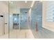 Modern walk-in shower features stylish blue tile and glass door in bathroom at 506 S Casey Key Rd, Nokomis, FL 34275