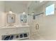 Bright bathroom featuring double vanity, an enclosed shower, and stylish lighting fixtures at 506 S Casey Key Rd, Nokomis, FL 34275