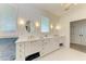 Bathroom features double sinks with marble counters and modern fixtures at 506 S Casey Key Rd, Nokomis, FL 34275
