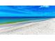 Picturesque beach with clear turquoise water and gentle waves, ideal for a peaceful escape at 506 S Casey Key Rd, Nokomis, FL 34275