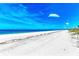 Serene beach with soft white sand and clear blue waters offers a tranquil coastal escape at 506 S Casey Key Rd, Nokomis, FL 34275