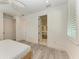 Bright bedroom featuring an ensuite bathroom, shuttered windows and a ceiling fan at 506 S Casey Key Rd, Nokomis, FL 34275