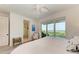 Ocean view bedroom with large bed, ensuite bathroom, and sliding glass doors to balcony at 506 S Casey Key Rd, Nokomis, FL 34275