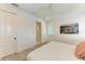 Bright bedroom with a woven bed frame, ensuite bathroom and beachy decor at 506 S Casey Key Rd, Nokomis, FL 34275