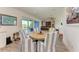 Casual dining area with round table and blue striped chairs, near bar at 506 S Casey Key Rd, Nokomis, FL 34275