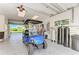 Garage featuring a golf cart, water treatment system, and access to the outdoors at 506 S Casey Key Rd, Nokomis, FL 34275