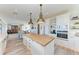 Modern kitchen with large island, white cabinets and ocean view at 506 S Casey Key Rd, Nokomis, FL 34275