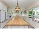 Bright and spacious kitchen featuring a large island, modern appliances, and ample counter space at 506 S Casey Key Rd, Nokomis, FL 34275