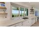 Kitchen with white marble countertops and a scenic ocean view at 506 S Casey Key Rd, Nokomis, FL 34275