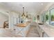 Bright, spacious kitchen featuring a large island, white cabinets, and high-end appliances at 506 S Casey Key Rd, Nokomis, FL 34275