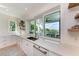 Kitchen with white marble counters and a view of the patio and ocean at 506 S Casey Key Rd, Nokomis, FL 34275