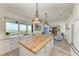 Kitchen with island, white cabinets and ocean view at 506 S Casey Key Rd, Nokomis, FL 34275